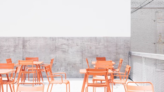 photo of a minimalist restaurant  with vibrant seating that is stamped of approval